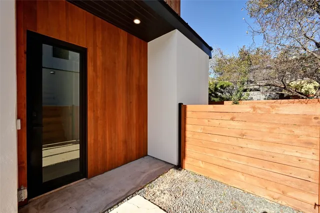 a view of wooden door and a wooden fence