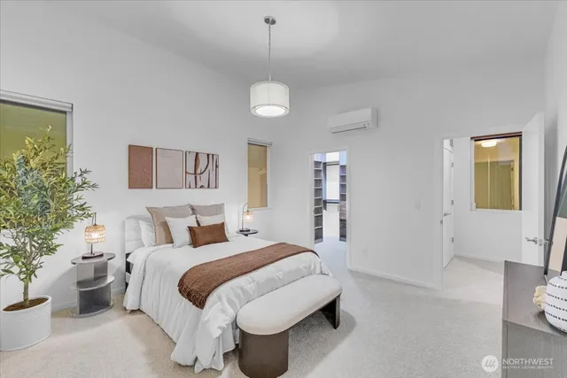 a spacious bedroom with a bed and a chandelier