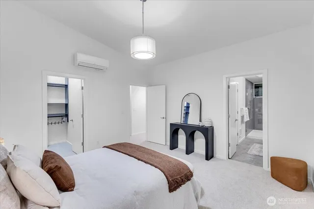 a bedroom with a bed and a large mirror