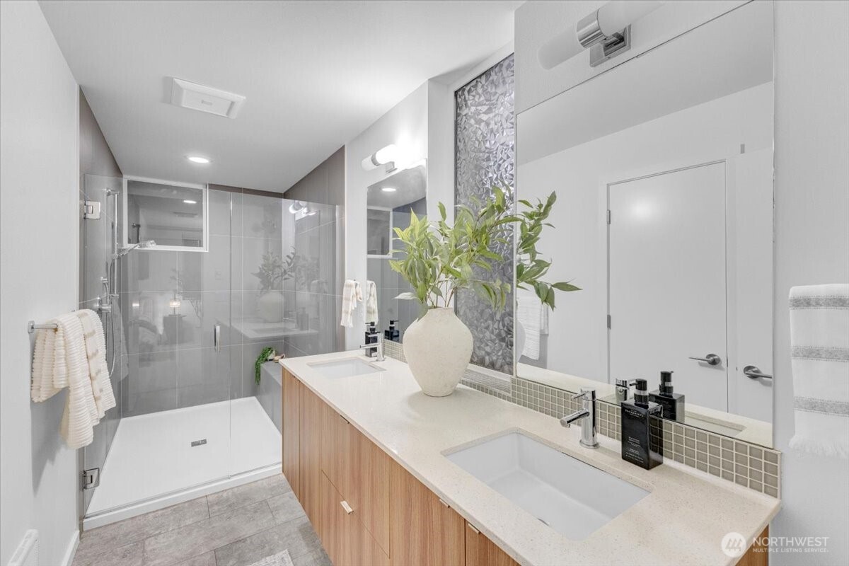 1722 Northwest 60th Street Seattle, WA 98107 - Photo 16 of 37 a bathroom with a double vanity sink a toilet and shower