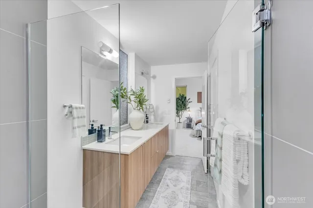 a bathroom with a double vanity sink and mirror