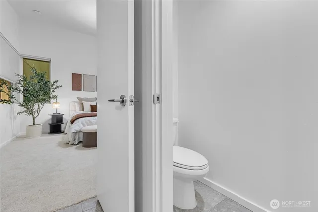 a bathroom with a toilet and a shower