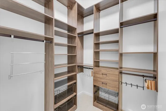 a view of walk in closet with empty racks