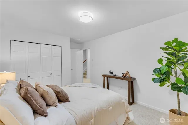 a bedroom with a bed and a potted plant
