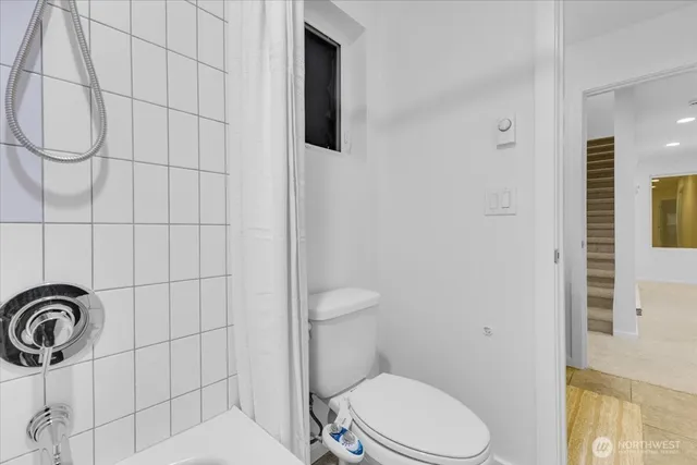 a white toilet sitting next to a bathroom sink