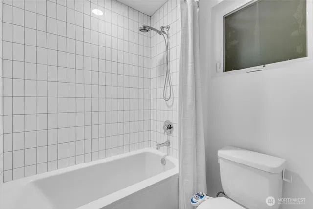 a bathroom with a bathtub and toilet