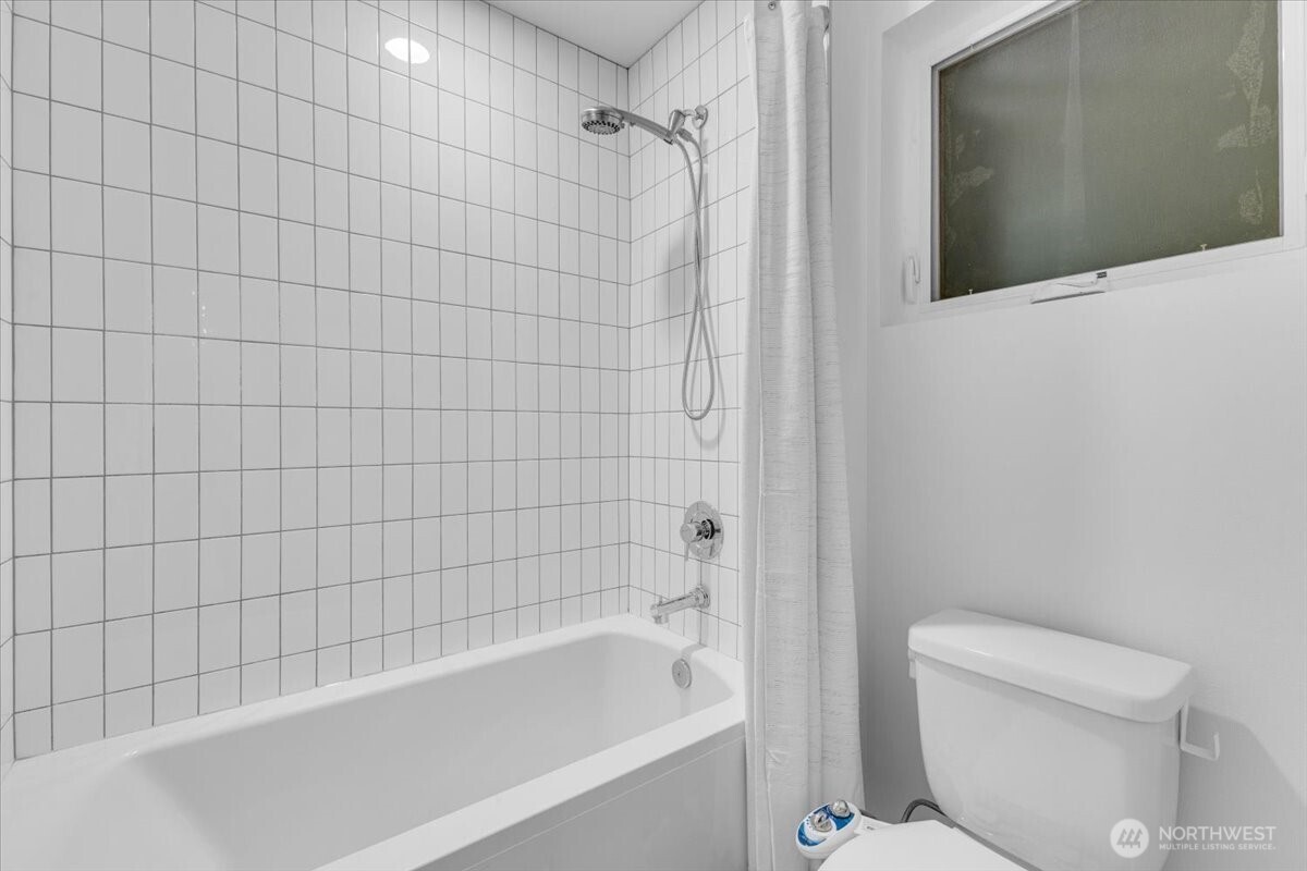 1722 Northwest 60th Street Seattle, WA 98107 - Photo 26 of 37 a bathroom with a bathtub and toilet