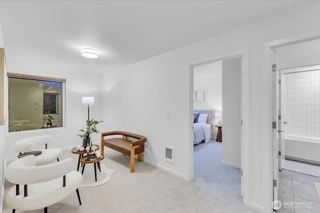 a living room with furniture and a mirror