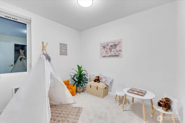 a hallway with a couch and a potted plant