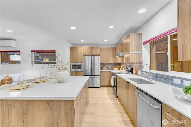 a kitchen with stainless steel appliances kitchen island granite countertop a sink and cabinets
