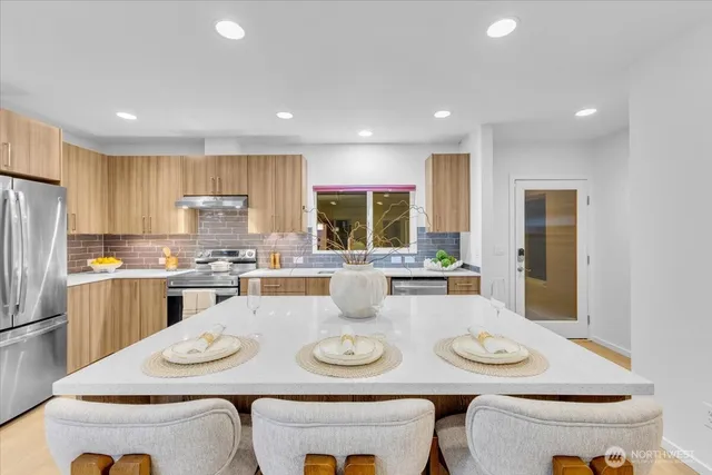 a kitchen with a dining table and chairs