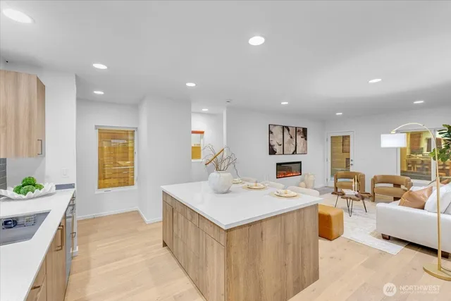 a living room with kitchen island furniture and a wooden floor