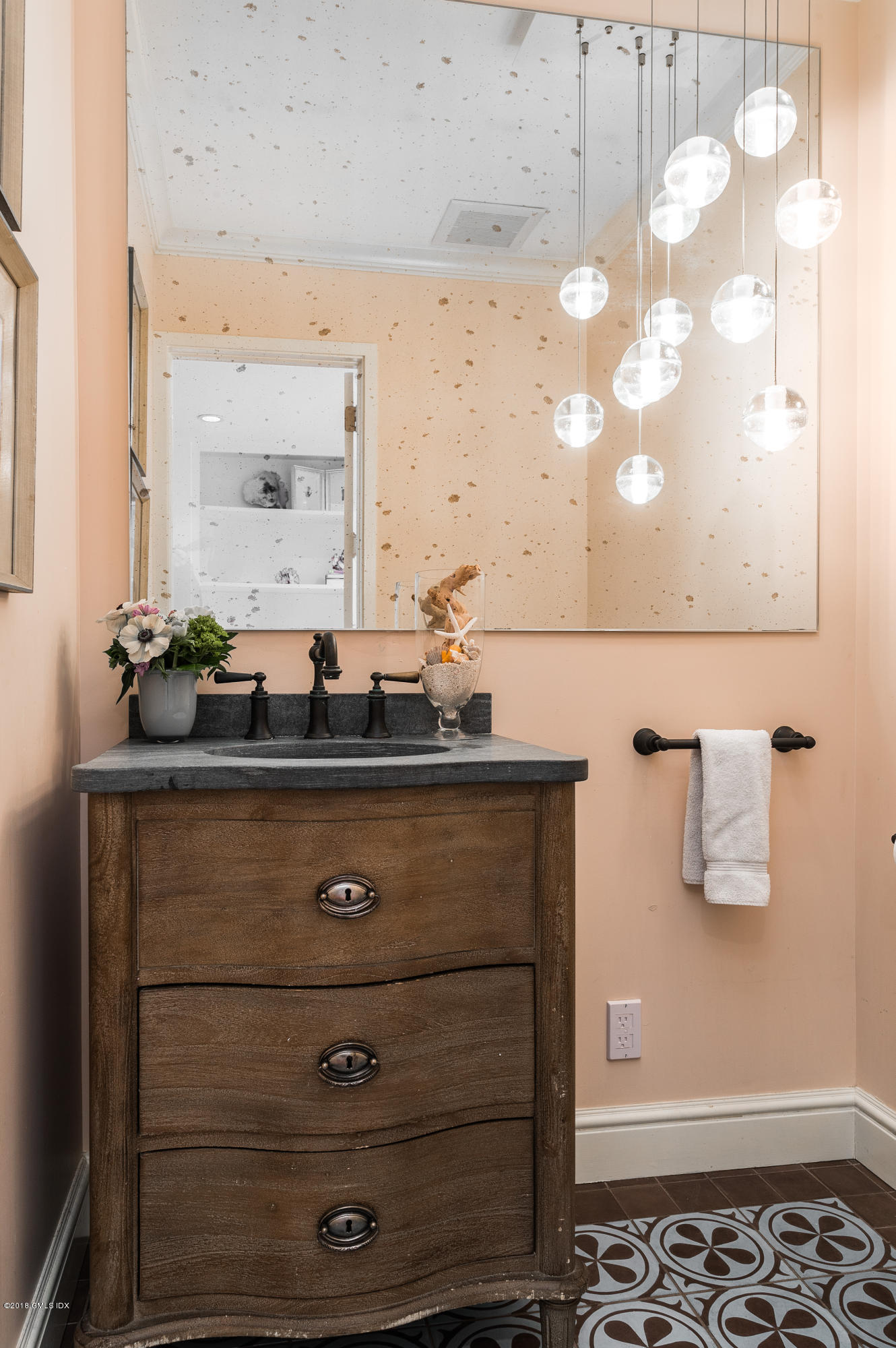 63 Burning Tree Road Greenwich, CT 06830 - Photo 12 of 40 a bathroom with a sink and a mirror