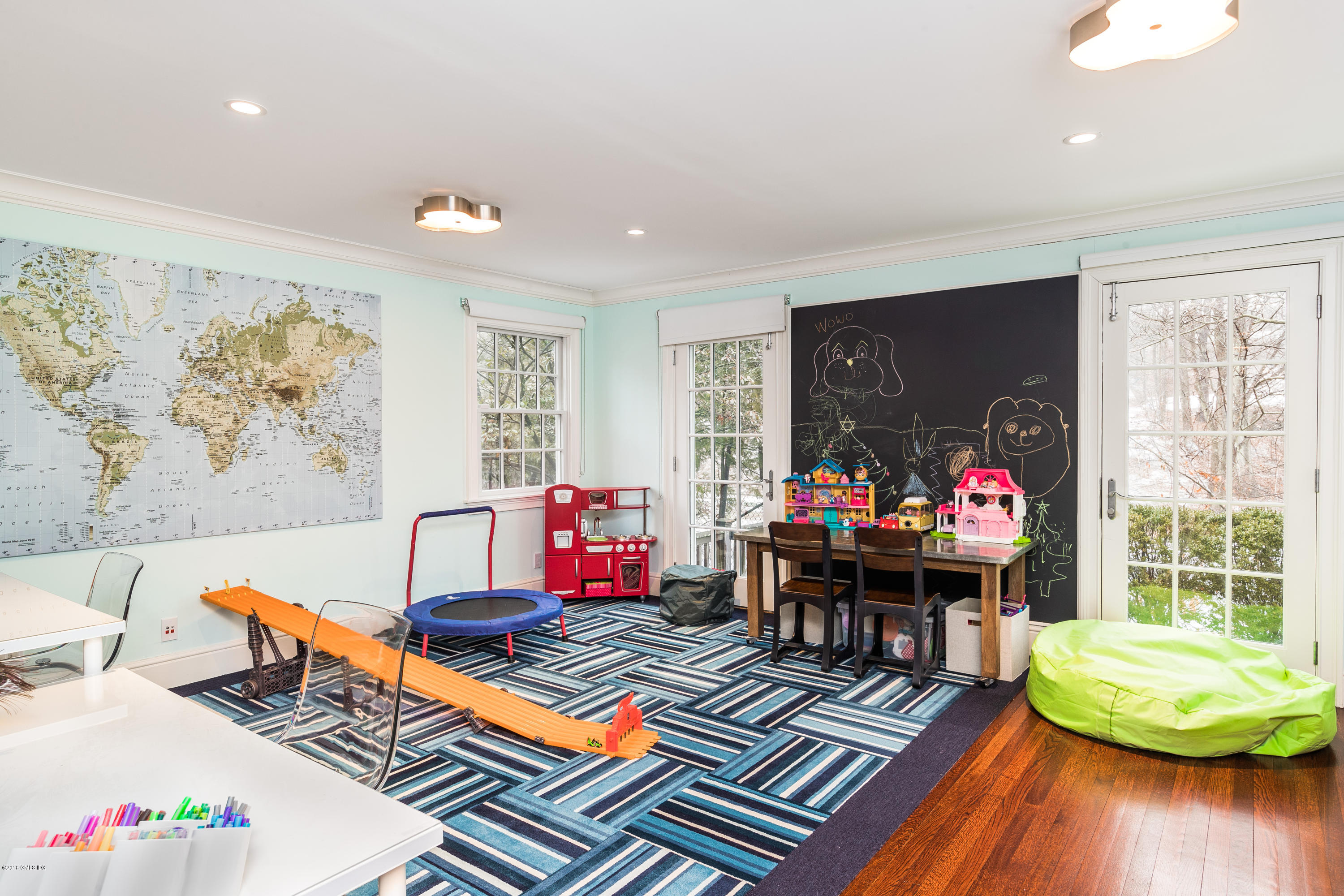 63 Burning Tree Road Greenwich, CT 06830 - Photo 15 of 40 a living room with furniture and a large window