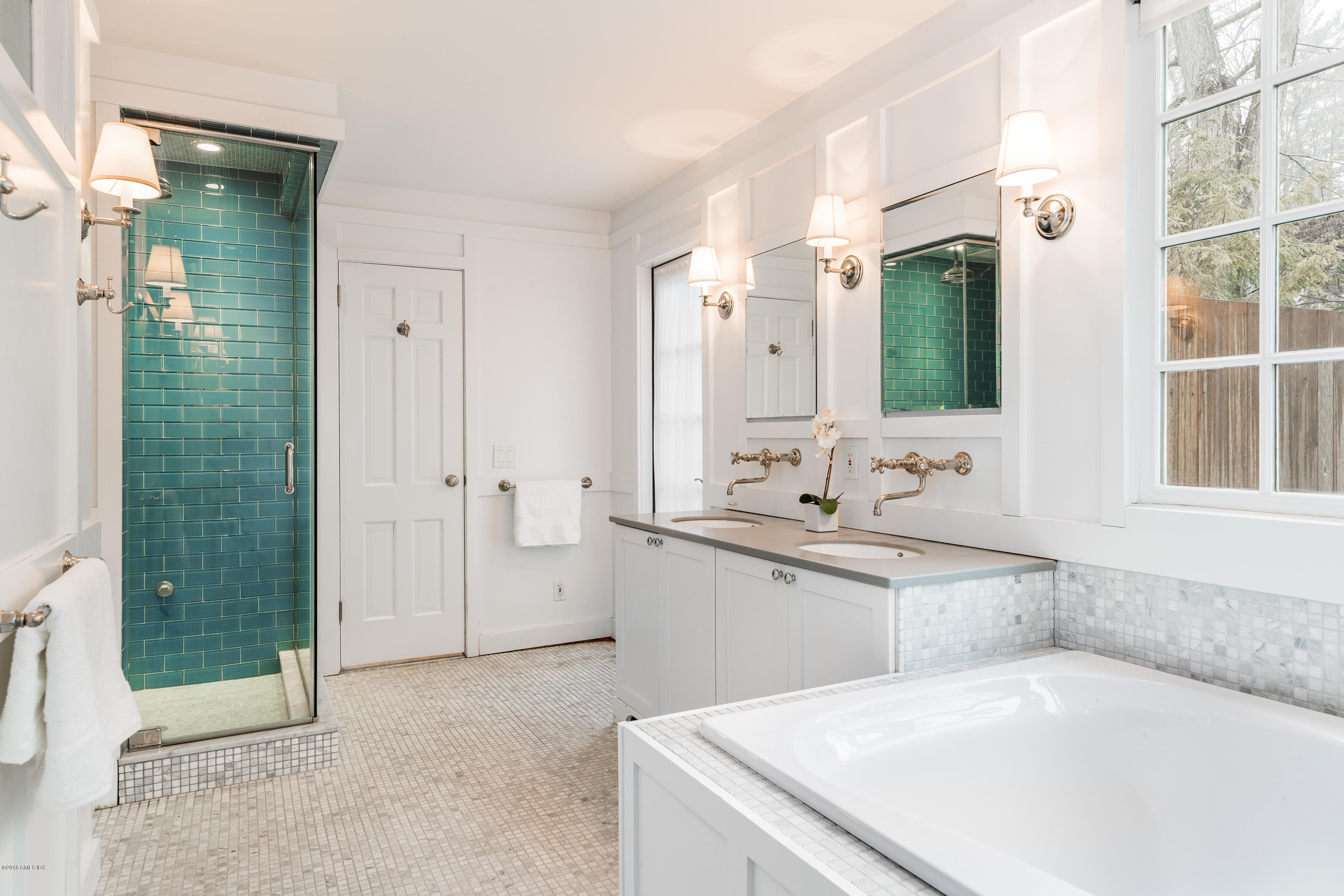 63 Burning Tree Road Greenwich, CT 06830 - Photo 16 of 40 a bathroom with a tub sink and mirror