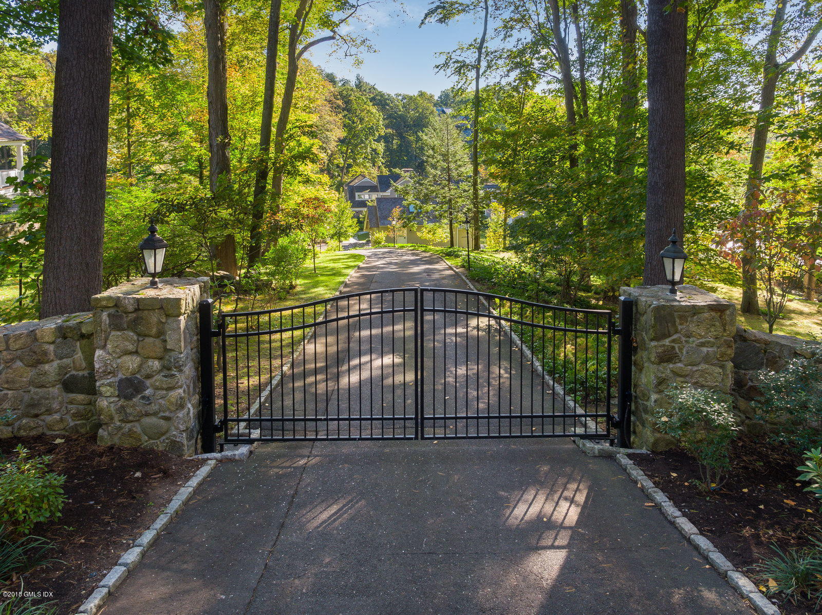 63 Burning Tree Road Greenwich, CT 06830 - Photo 2 of 40 a view of a backyard with a trees