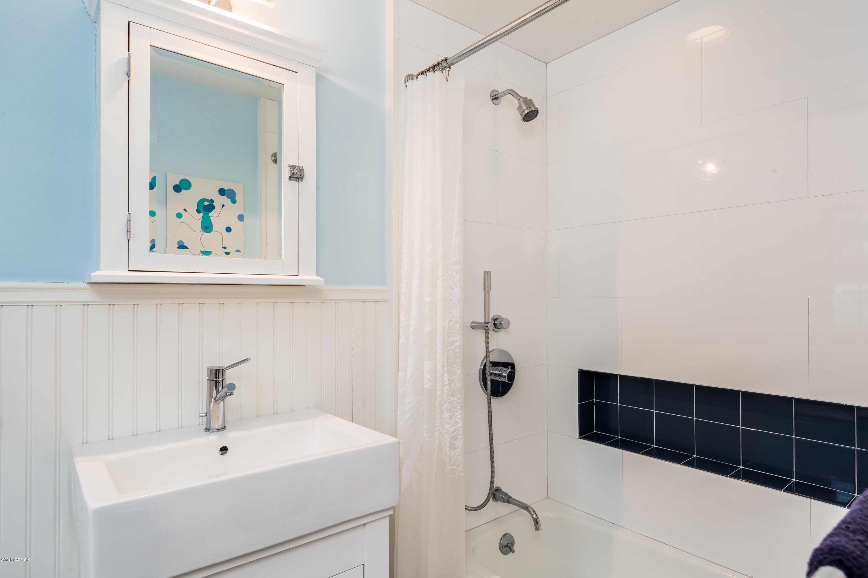 63 Burning Tree Road Greenwich, CT 06830 - Photo 27 of 40 a bathroom with a sink and mirror