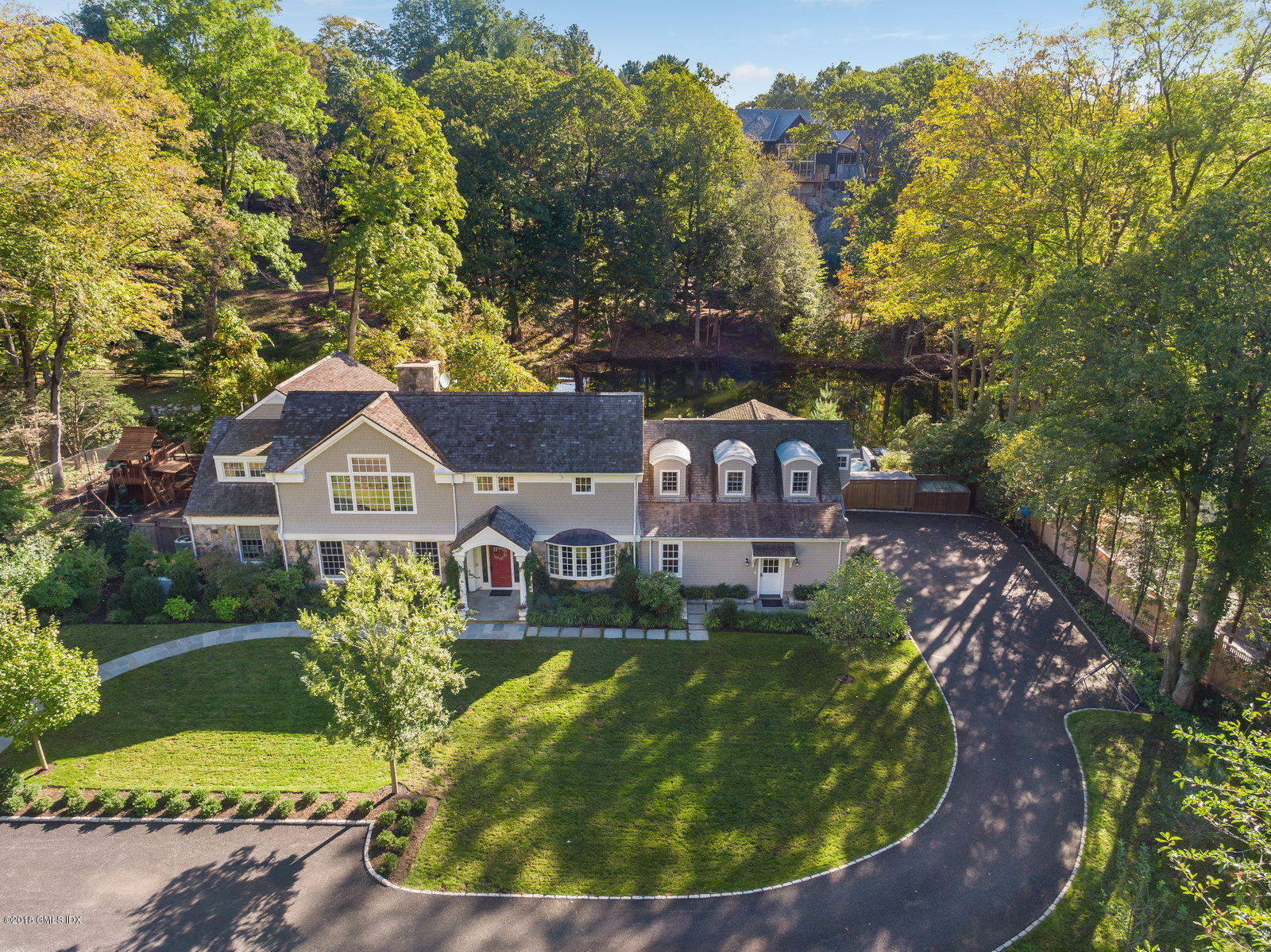 63 Burning Tree Road Greenwich, CT 06830 - Photo 3 of 40 a view of a house with a yard and sitting area