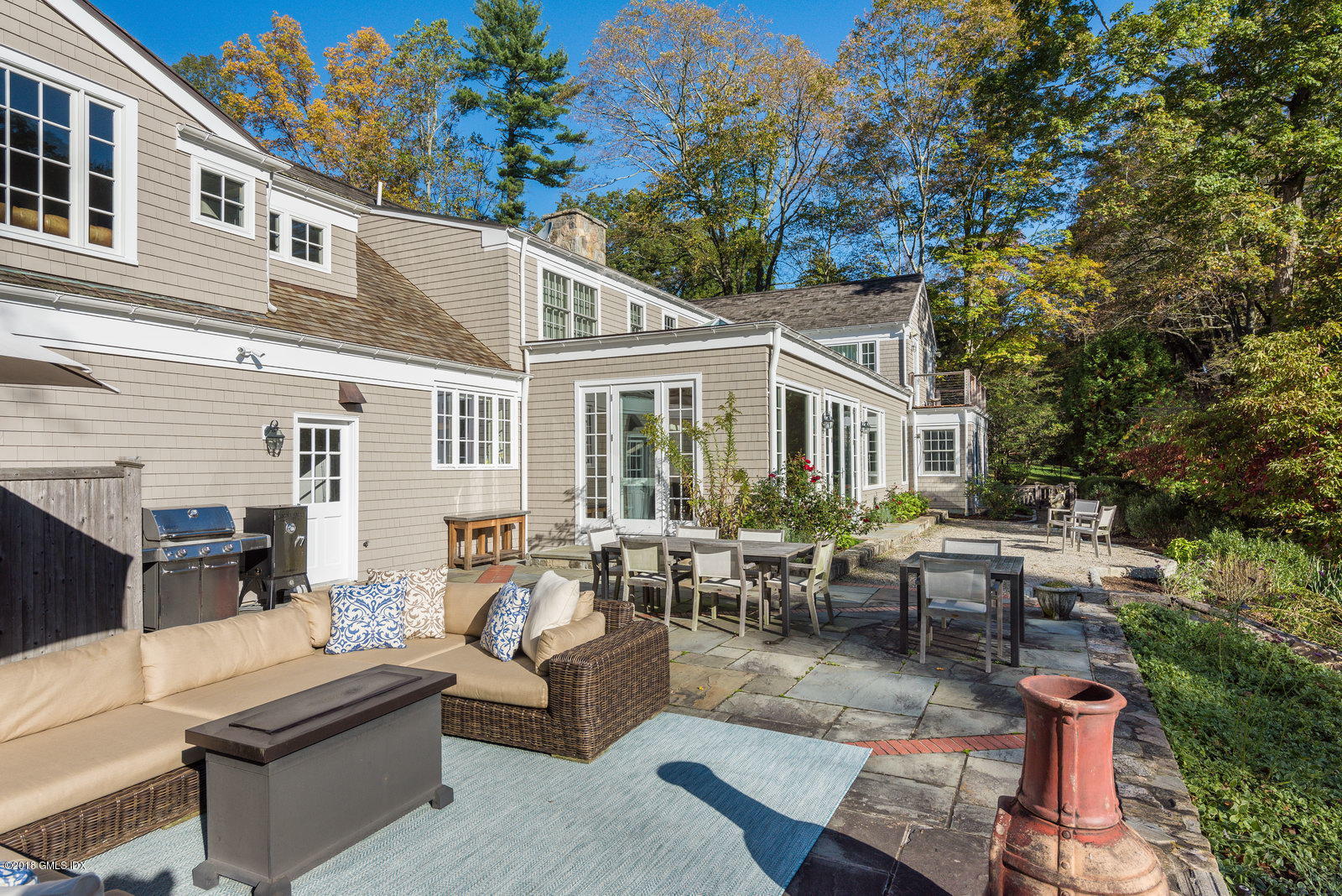 63 Burning Tree Road Greenwich, CT 06830 - Photo 34 of 40 a view of a patio with couches table and chairs and potted plants
