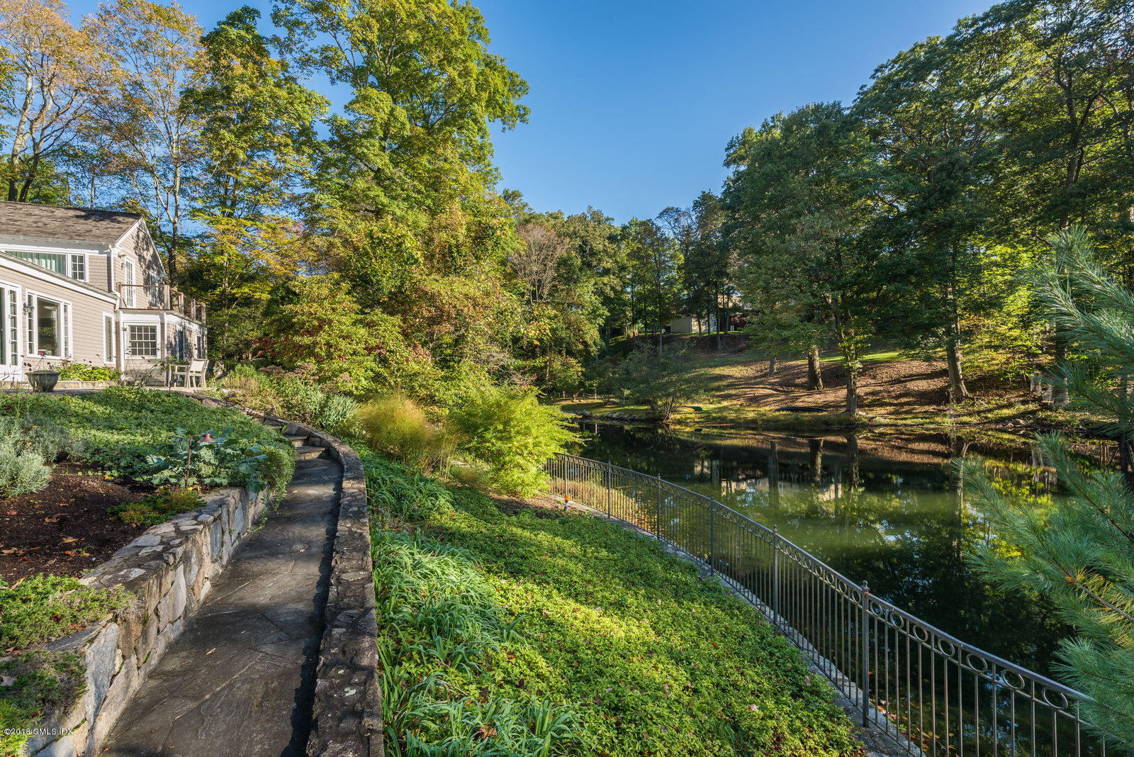 63 Burning Tree Road Greenwich, CT 06830 - Photo 35 of 40 a view of a lake with a yard