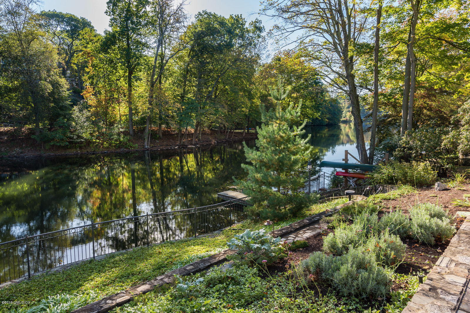 63 Burning Tree Road Greenwich, CT 06830 - Photo 4 of 40 a backyard of a house with a yard and outdoor seating