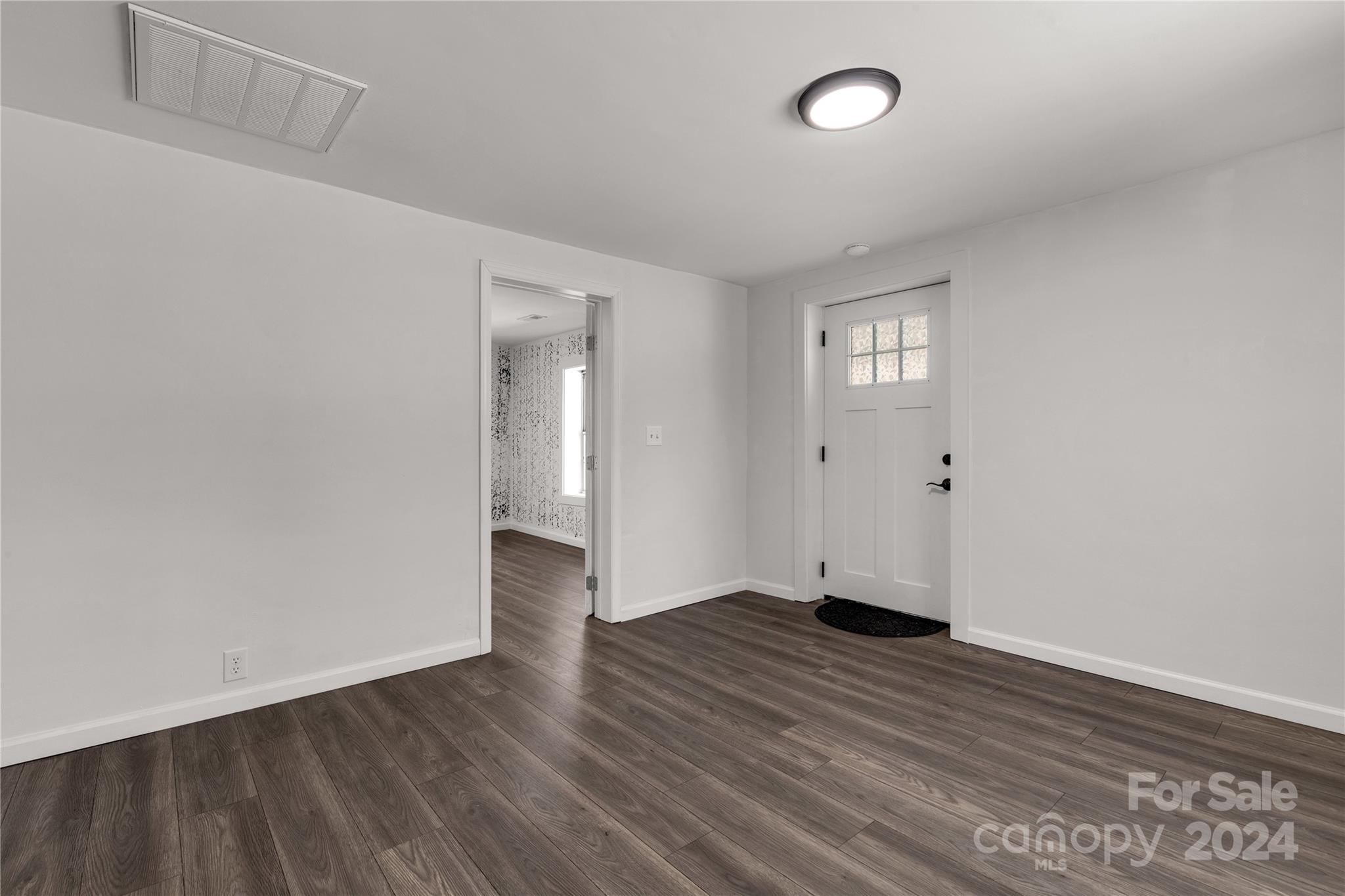 1439 Old Landsford Road Lancaster, SC 29720 - Photo 8 of 21 a view of an empty room with wooden floor and a window