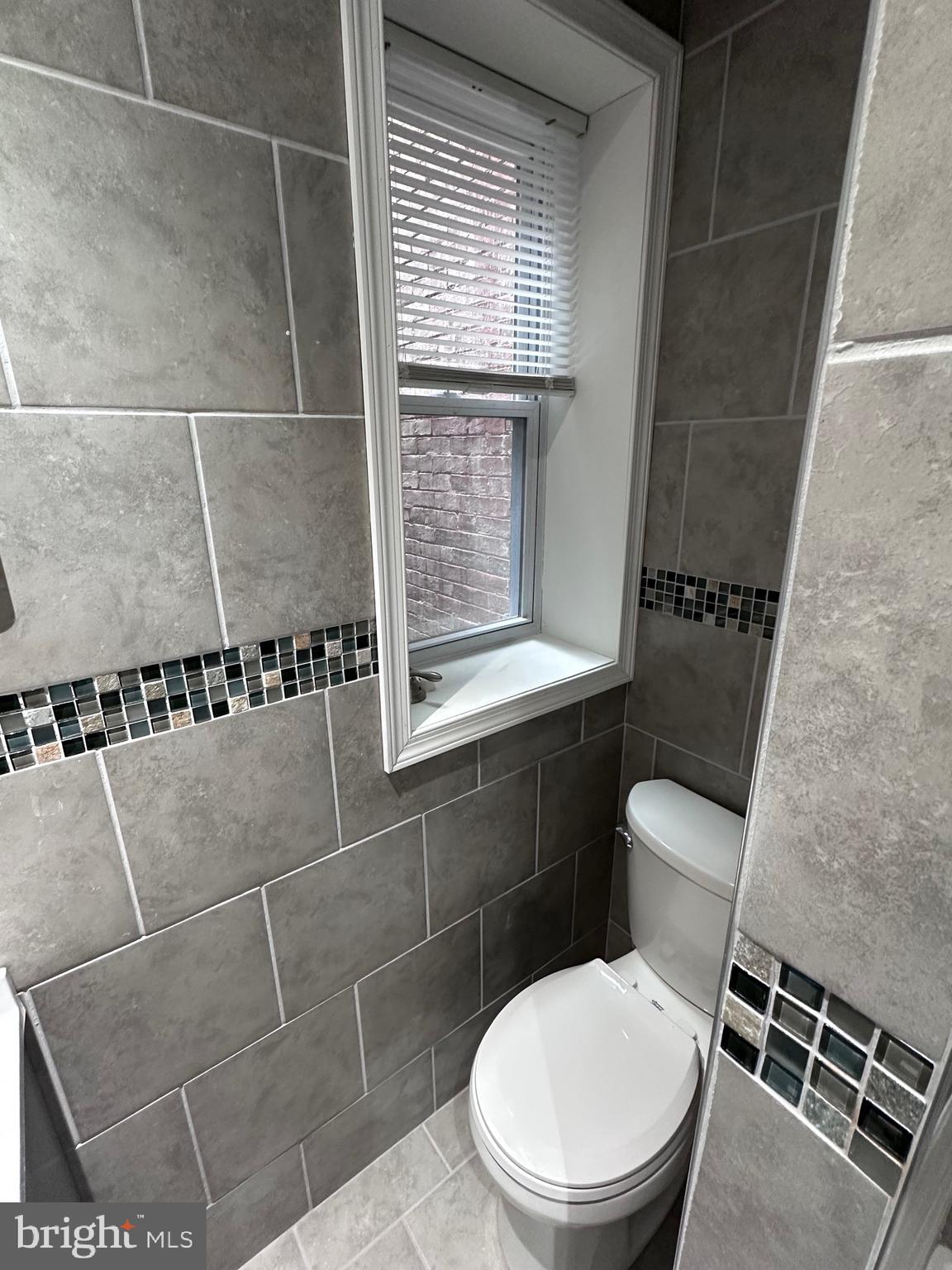 5254 Jefferson Street Philadelphia, PA 19131 - Photo 13 of 30 a white toilet sitting next to a window