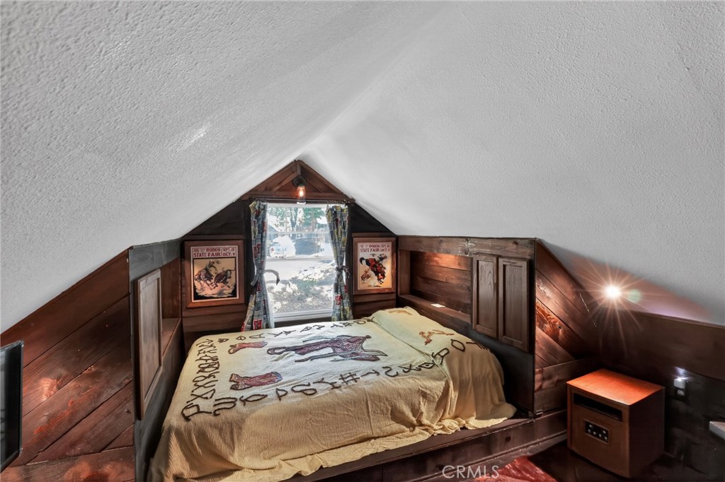 2775 View Running Springs, CA 92382 - Photo 24 of 30 a bed sitting in a bedroom next to a window