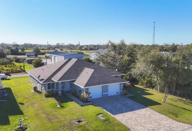 an aerial view of a house with a big yard