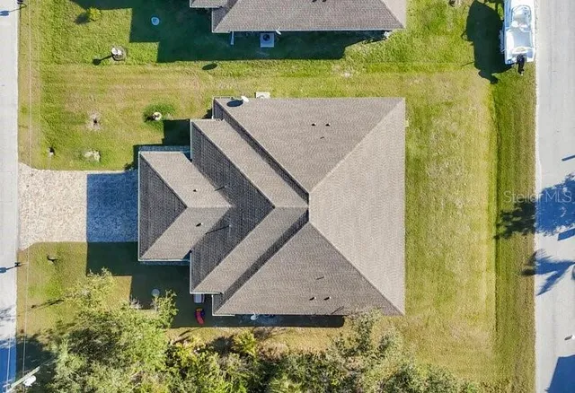 an aerial view of a house with a yard