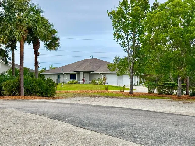 a view of swimming pool with palm trees