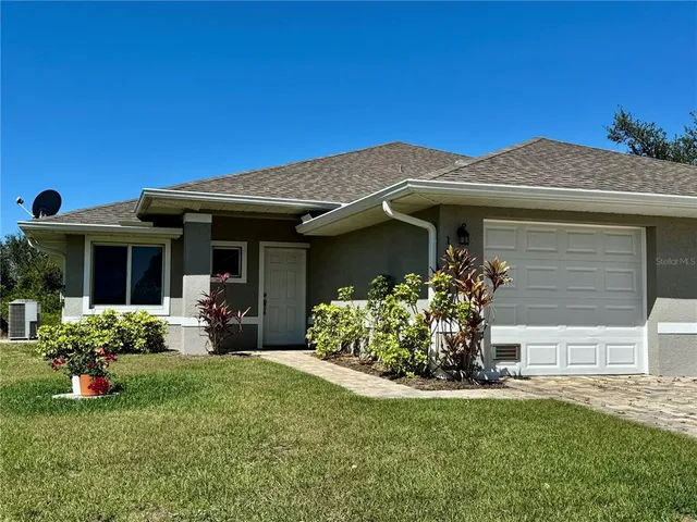 a front view of a house with a garden and porch