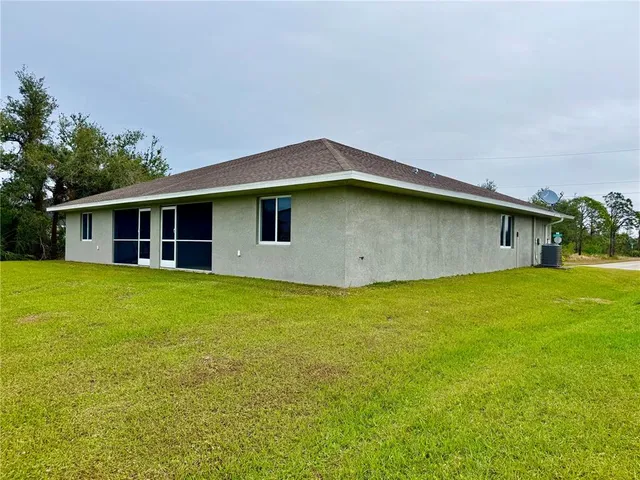 a front view of a house with a garden and yard
