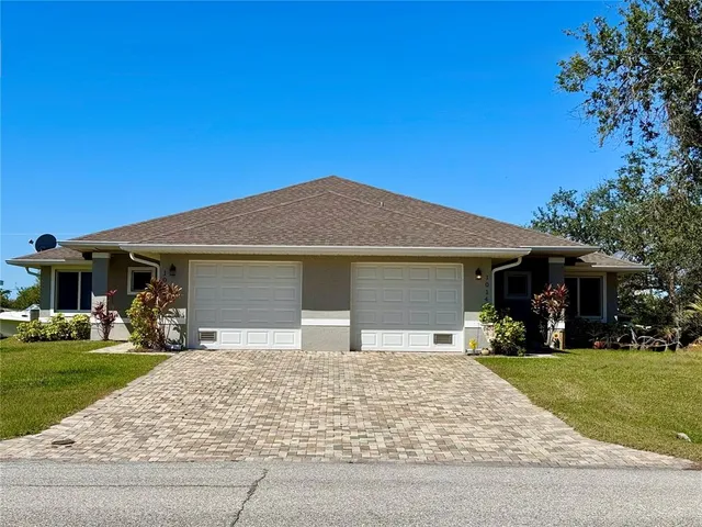 a front view of a house with a garden and yard