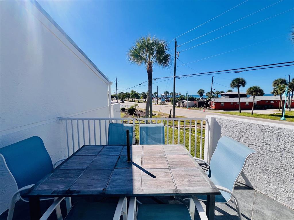2255 North Beach Road, Unit 13 Englewood, FL 34223 - Photo 12 of 69 a view of a chairs and table in patio
