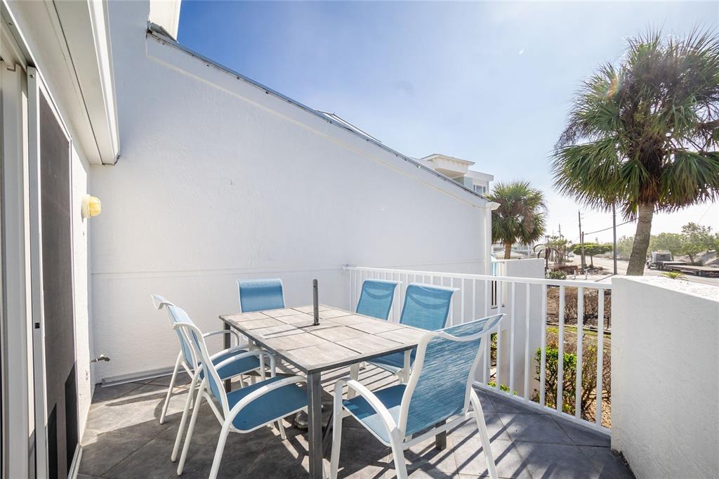 2255 North Beach Road, Unit 13 Englewood, FL 34223 - Photo 15 of 69 a view of a patio with a table and chairs