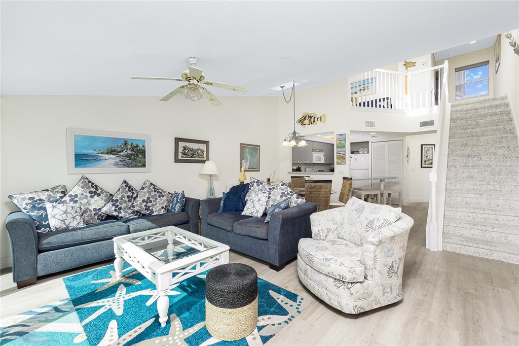 2255 North Beach Road, Unit 13 Englewood, FL 34223 - Photo 17 of 69 a living room with furniture and a chandelier