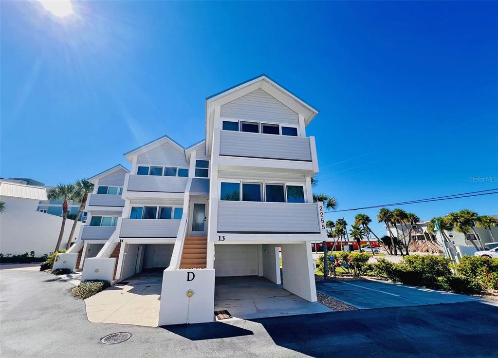 2255 North Beach Road, Unit 13 Englewood, FL 34223 - Photo 2 of 69 a front view of a house with a yard