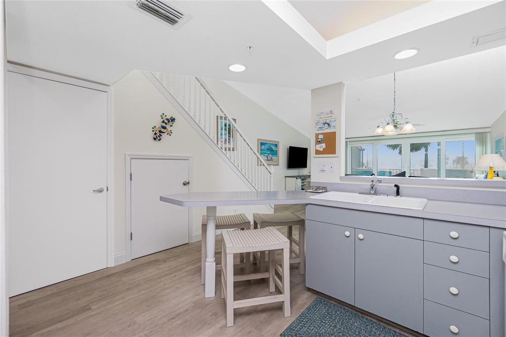 2255 North Beach Road, Unit 13 Englewood, FL 34223 - Photo 21 of 69 a kitchen with a sink cabinets and wooden floor