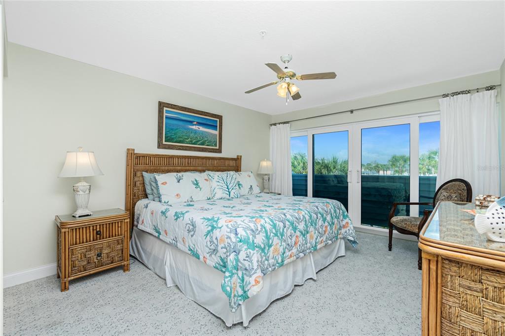 2255 North Beach Road, Unit 13 Englewood, FL 34223 - Photo 30 of 69 a bedroom with a bed a couch and large window