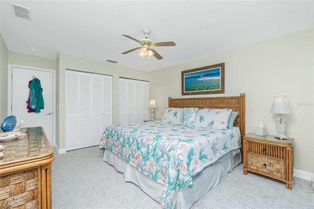 2255 North Beach Road, Unit 13 Englewood, FL 34223 - Photo 32 of 69 a bedroom with a bed and a chandelier