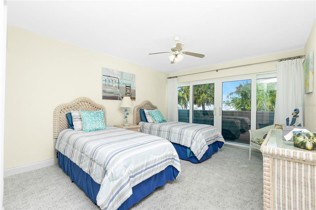 2255 North Beach Road, Unit 13 Englewood, FL 34223 - Photo 34 of 69 a bedroom with two beds and large window