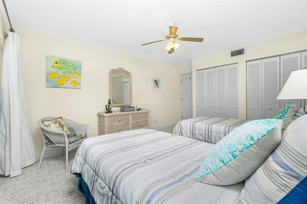 2255 North Beach Road, Unit 13 Englewood, FL 34223 - Photo 35 of 69 a bedroom with a bed and a chandelier