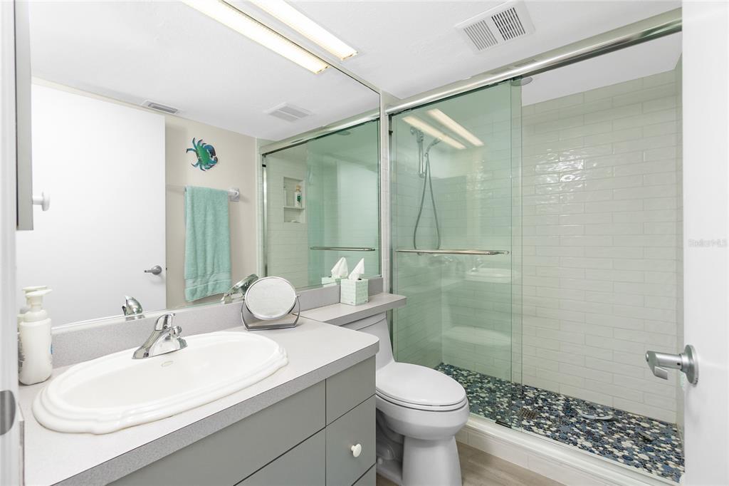 2255 North Beach Road, Unit 13 Englewood, FL 34223 - Photo 36 of 69 a bathroom with a sink toilet and shower