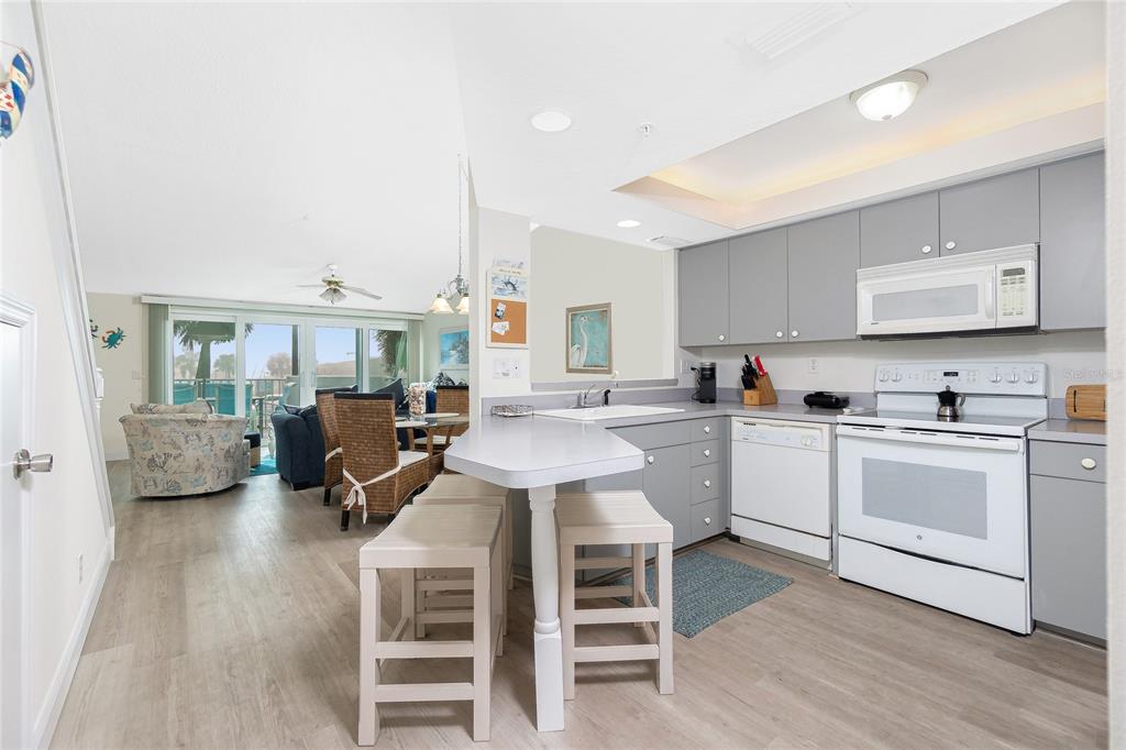 2255 North Beach Road, Unit 13 Englewood, FL 34223 - Photo 6 of 69 a kitchen with a sink cabinets and wooden floor