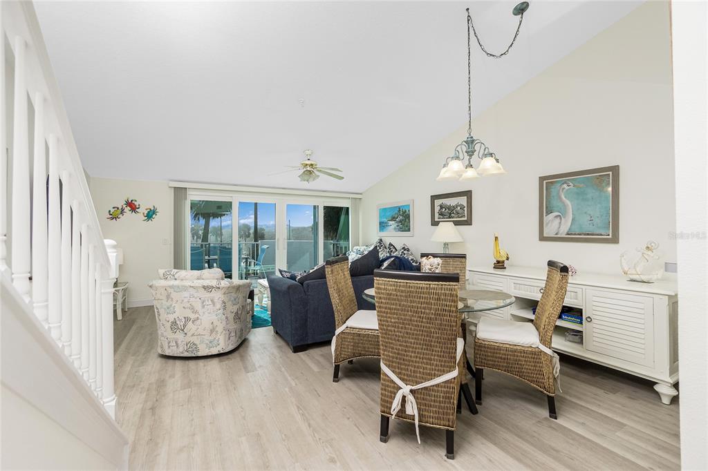 2255 North Beach Road, Unit 13 Englewood, FL 34223 - Photo 7 of 69 a living room with furniture a chandelier and a window