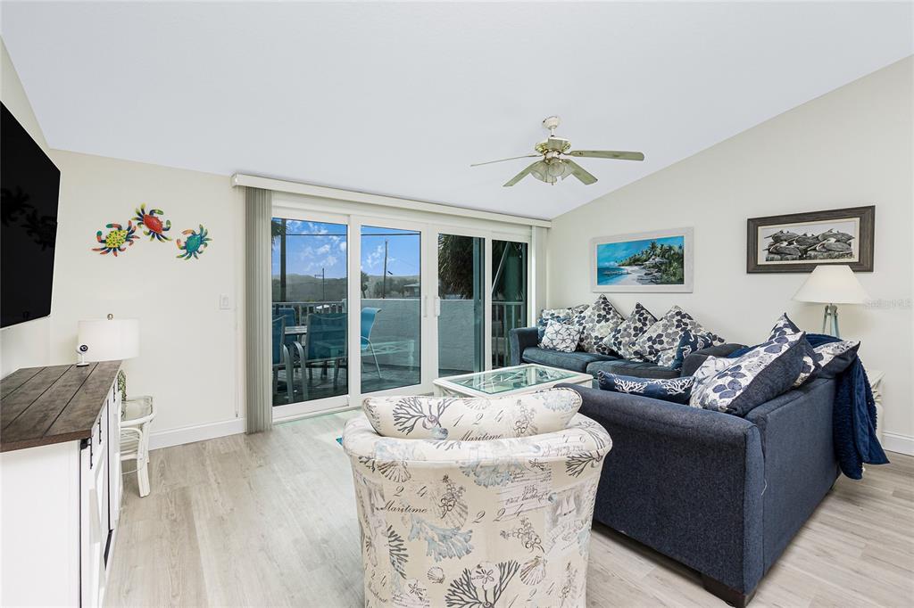 2255 North Beach Road, Unit 13 Englewood, FL 34223 - Photo 9 of 69 a living room with furniture and a flat screen tv