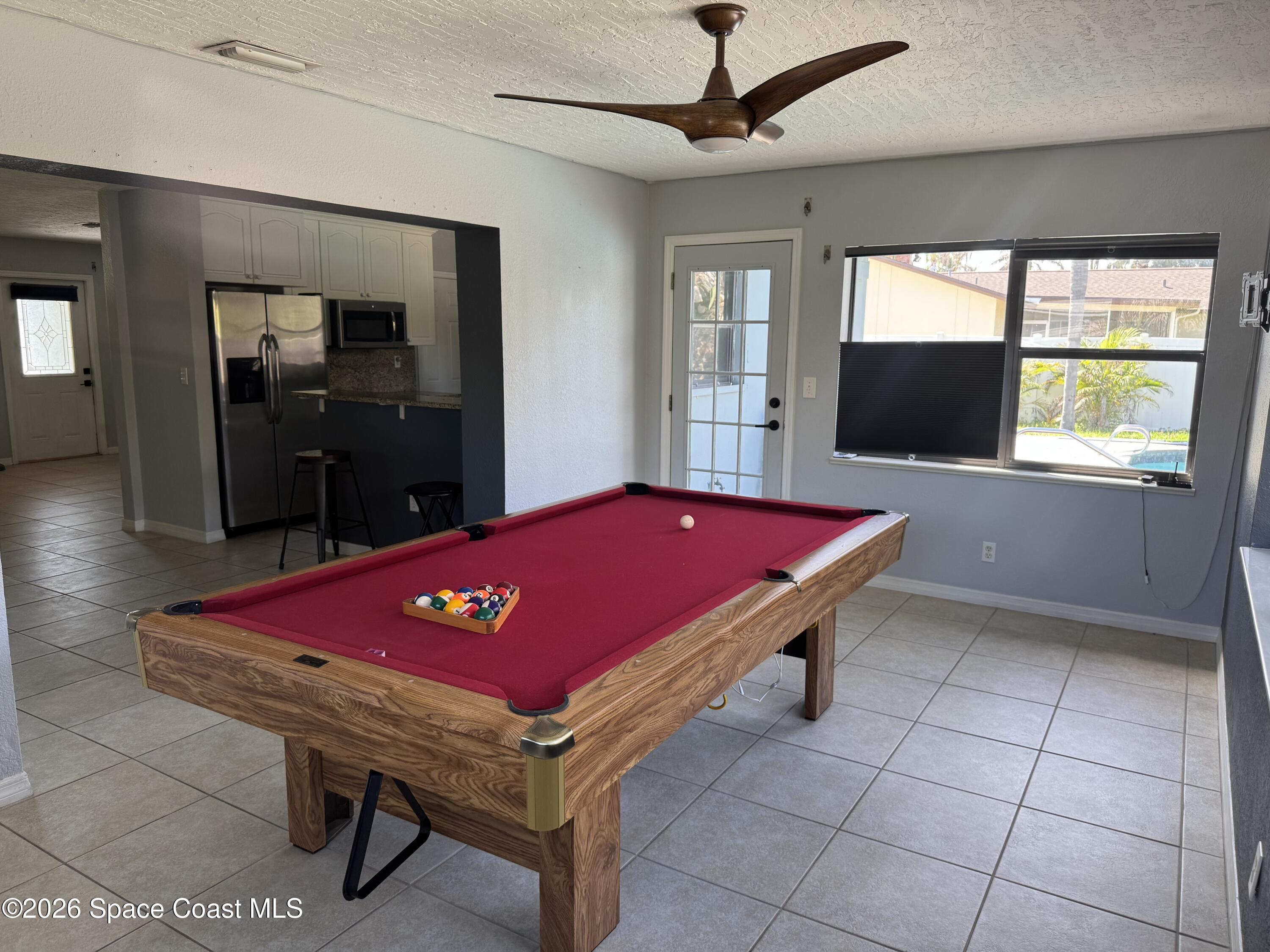 2135 South River Road Melbourne Beach, FL 32951 - Photo 5 of 14 a room with pool table and windows