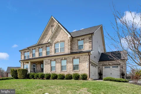 a view of a house with backyard sitting area and garden