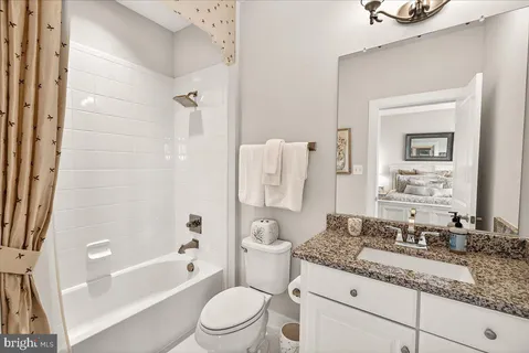 a living room with furniture kitchen view and a large window